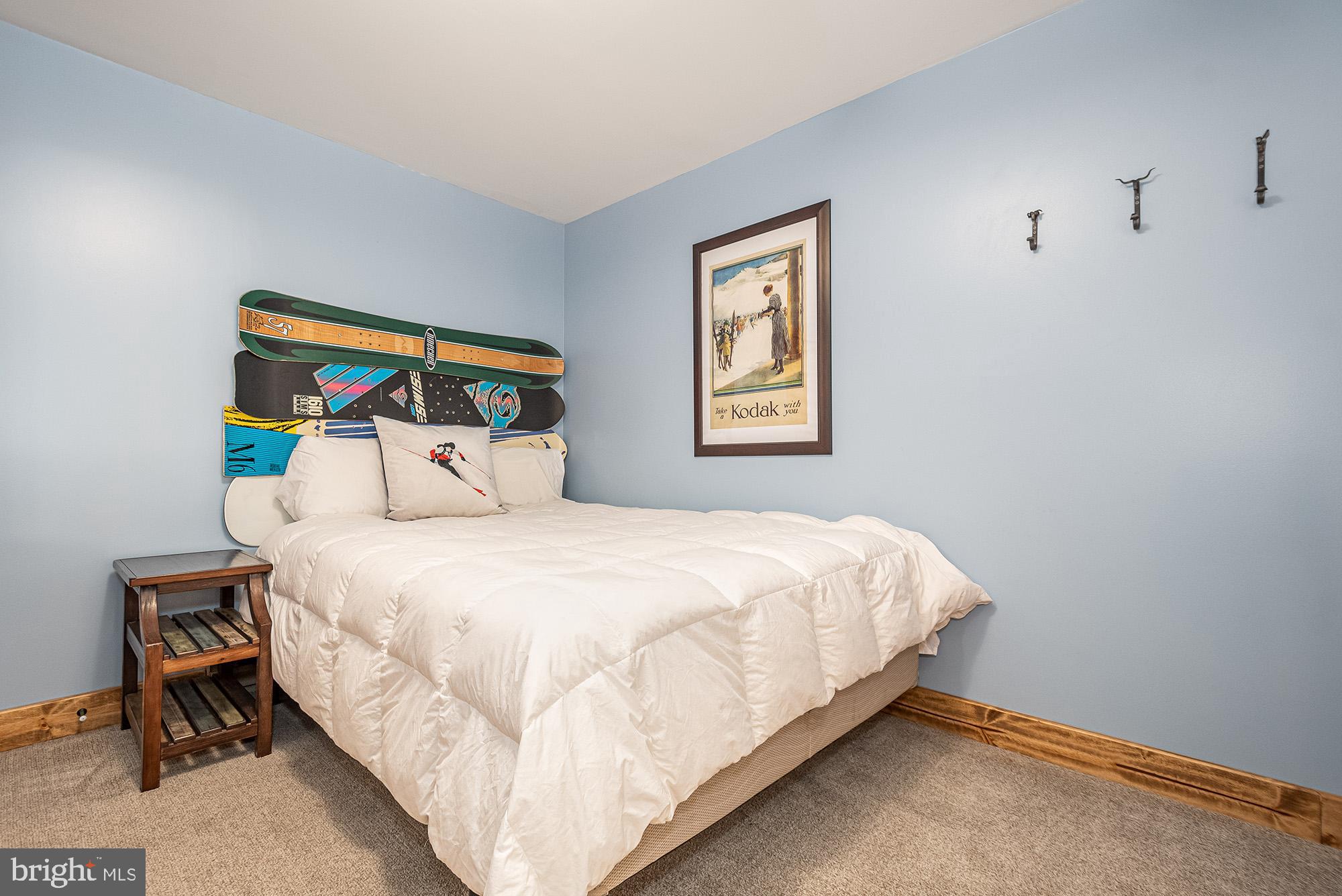 12 Winding Way, Unit 18A McHenry, MD 21541 - Photo 20 of 35 a large bed sitting in a bedroom next to a window
