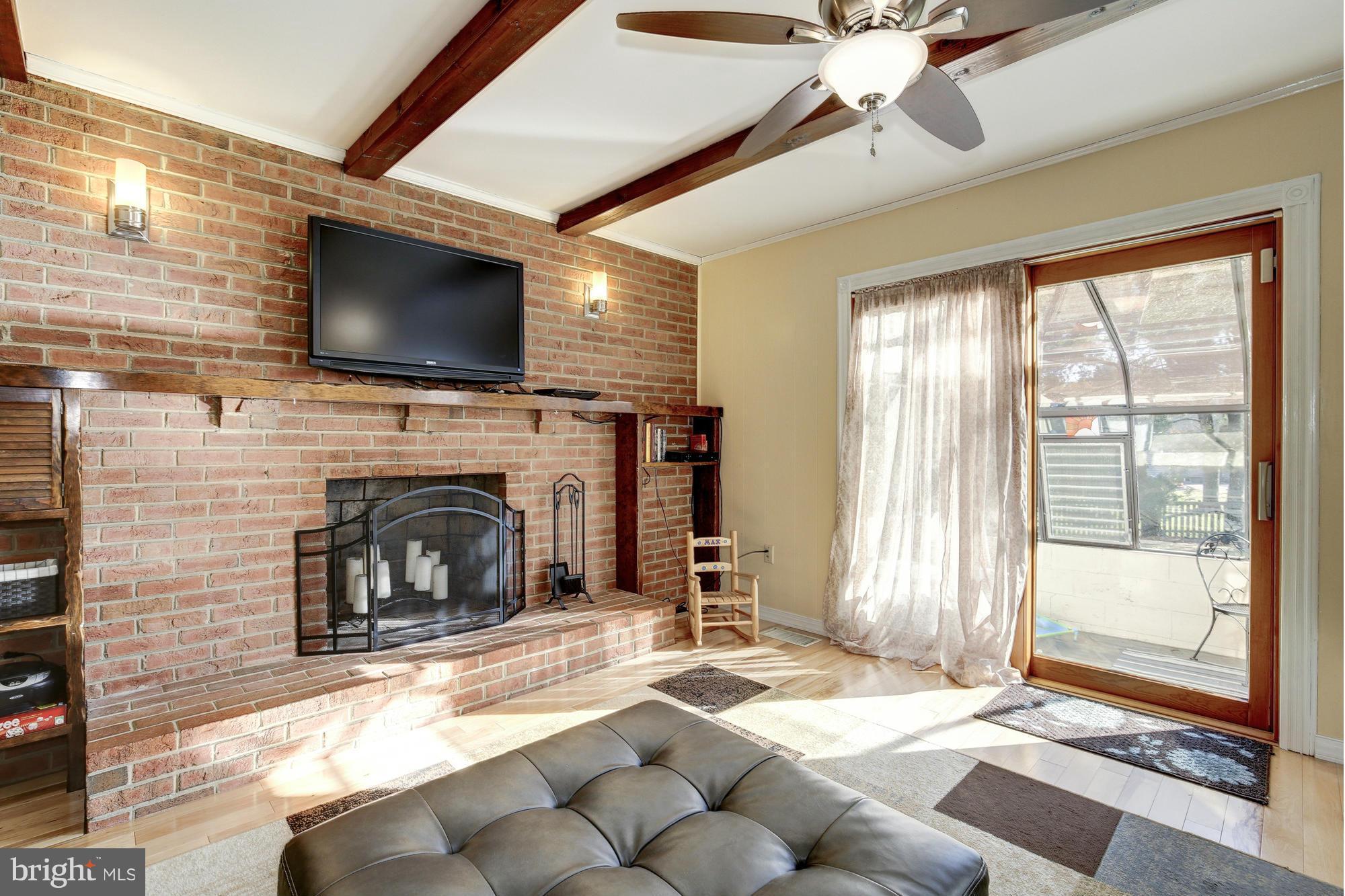 6505 Darwin Road Laurel, MD 20707 - Photo 13 of 30 a living room with fireplace furniture and a flat screen tv
