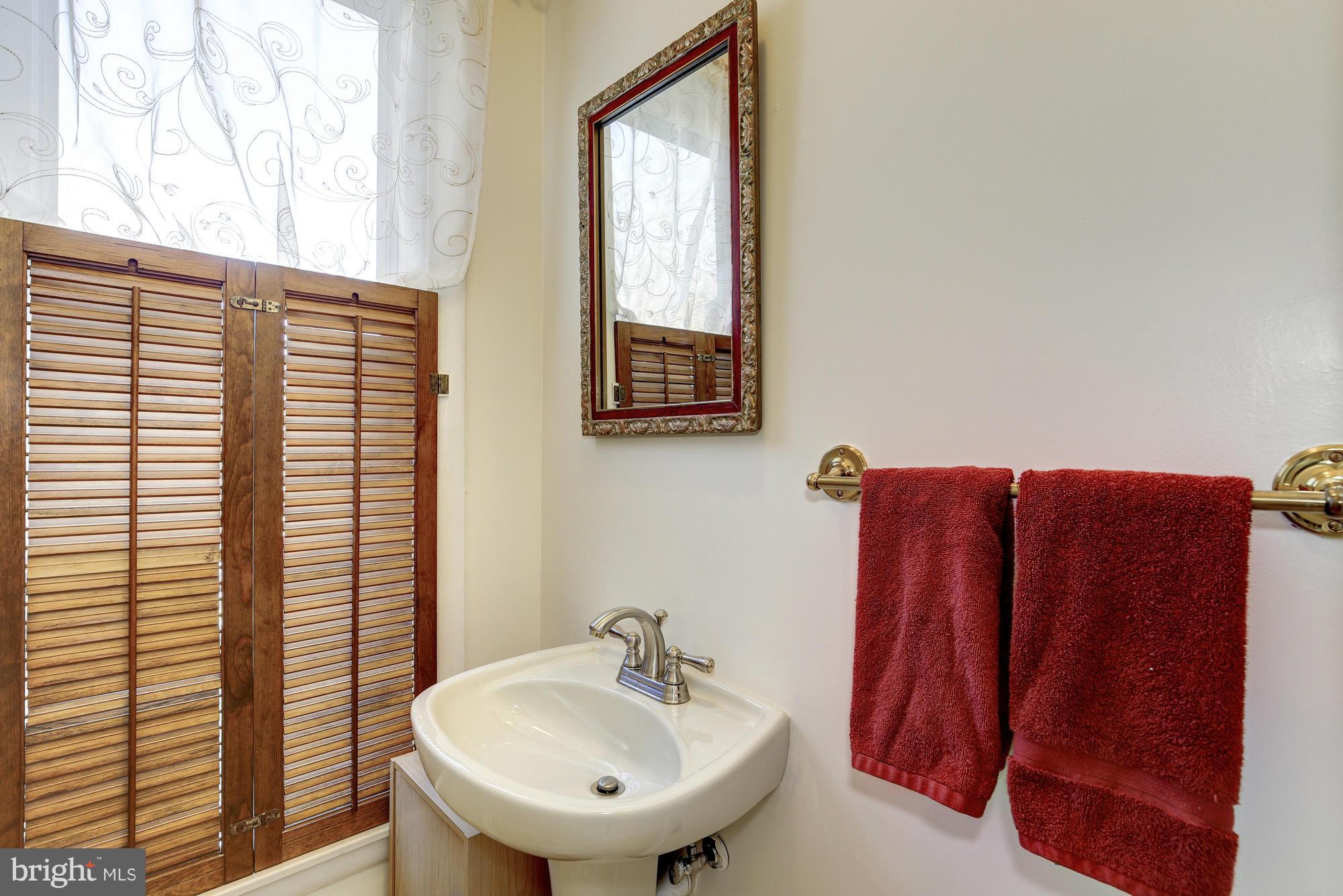 6505 Darwin Road Laurel, MD 20707 - Photo 15 of 30 a bathroom with a sink and a mirror