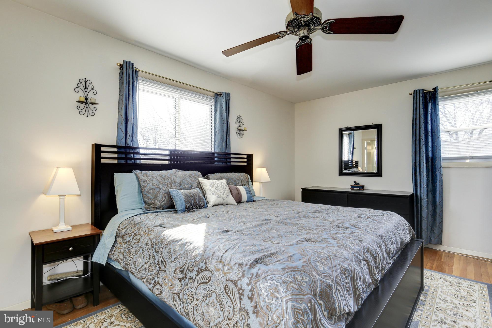 6505 Darwin Road Laurel, MD 20707 - Photo 16 of 30 a bedroom with a large bed and a chandelier