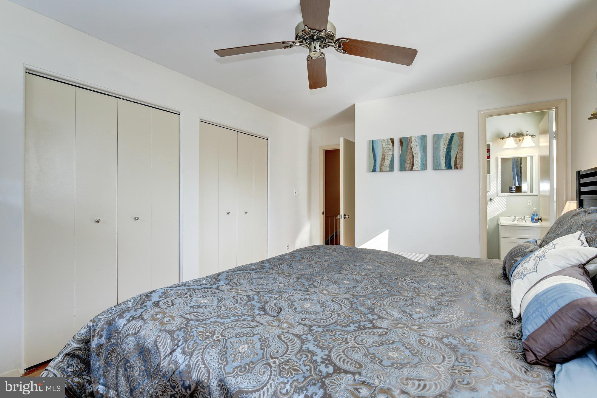 6505 Darwin Road Laurel, MD 20707 - Photo 17 of 30 a bedroom with a large bed and a chandelier