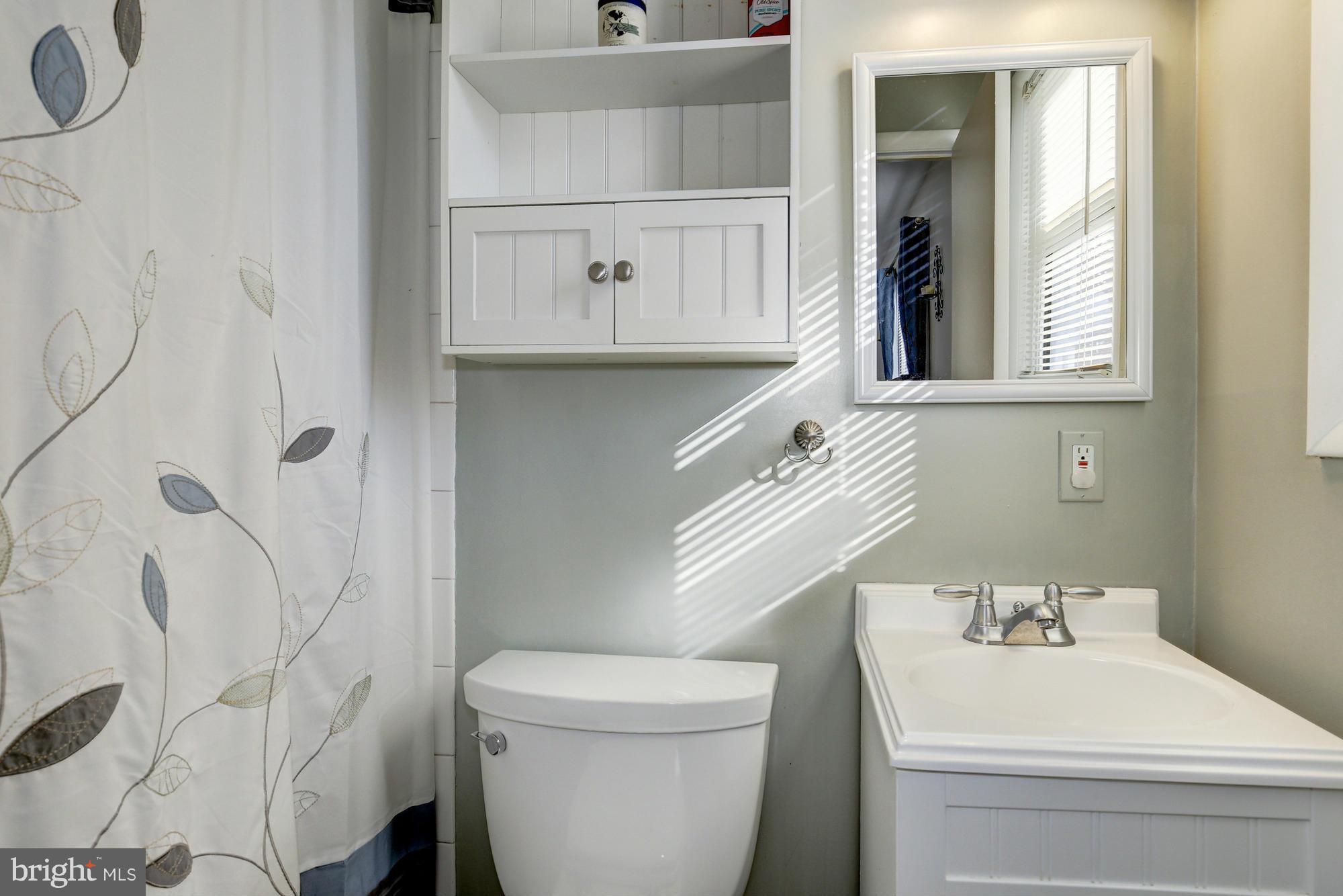 6505 Darwin Road Laurel, MD 20707 - Photo 18 of 30 a bathroom with a sink a toilet and shower