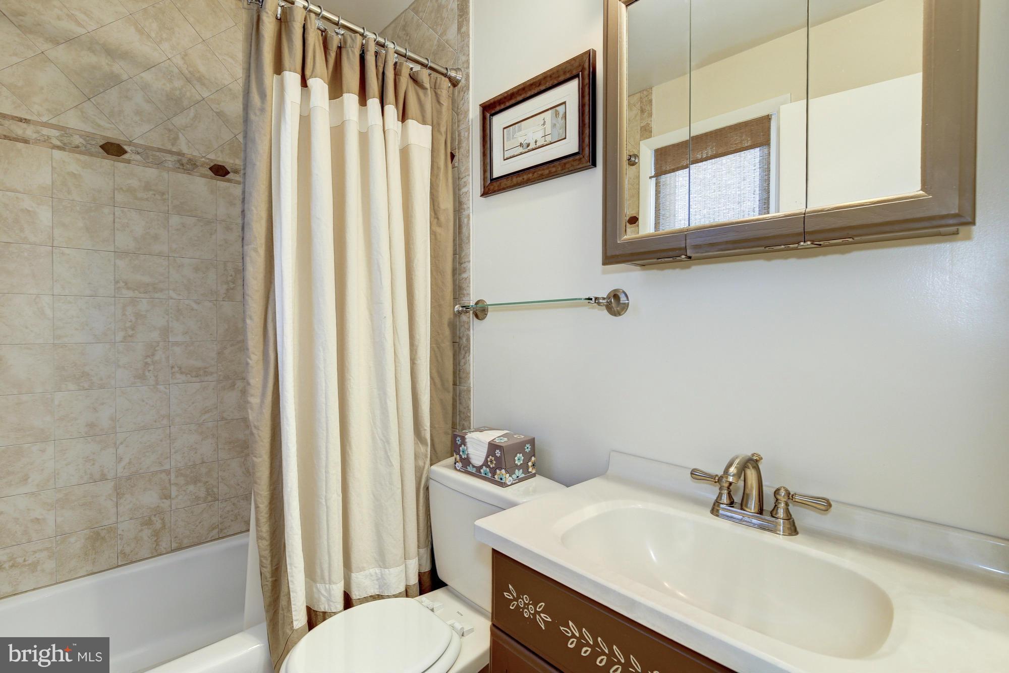 6505 Darwin Road Laurel, MD 20707 - Photo 23 of 30 a bathroom with a sink and a mirror