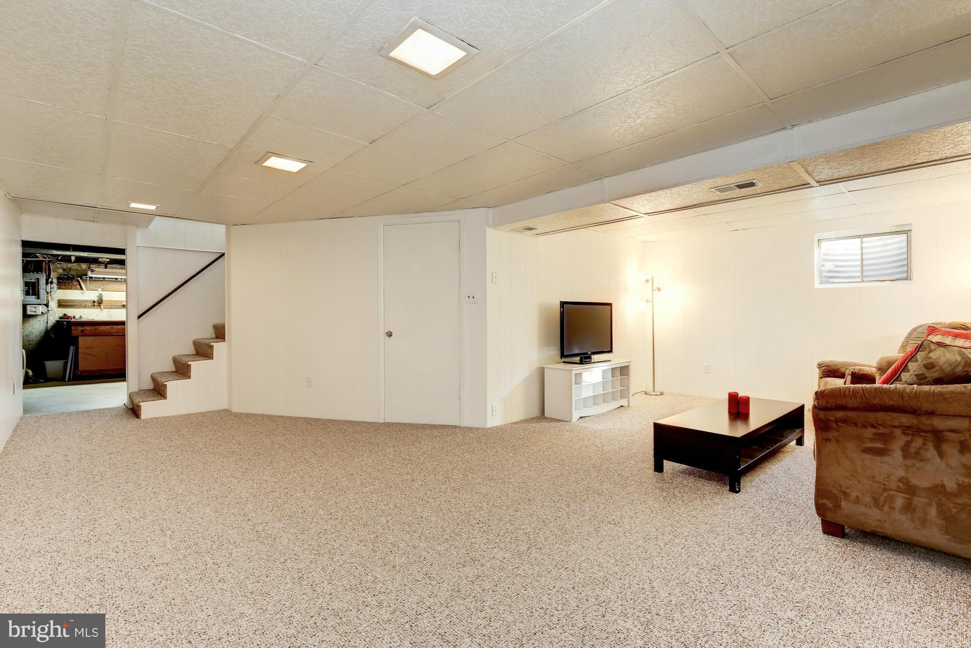 6505 Darwin Road Laurel, MD 20707 - Photo 24 of 30 a living room with furniture and a flat screen tv