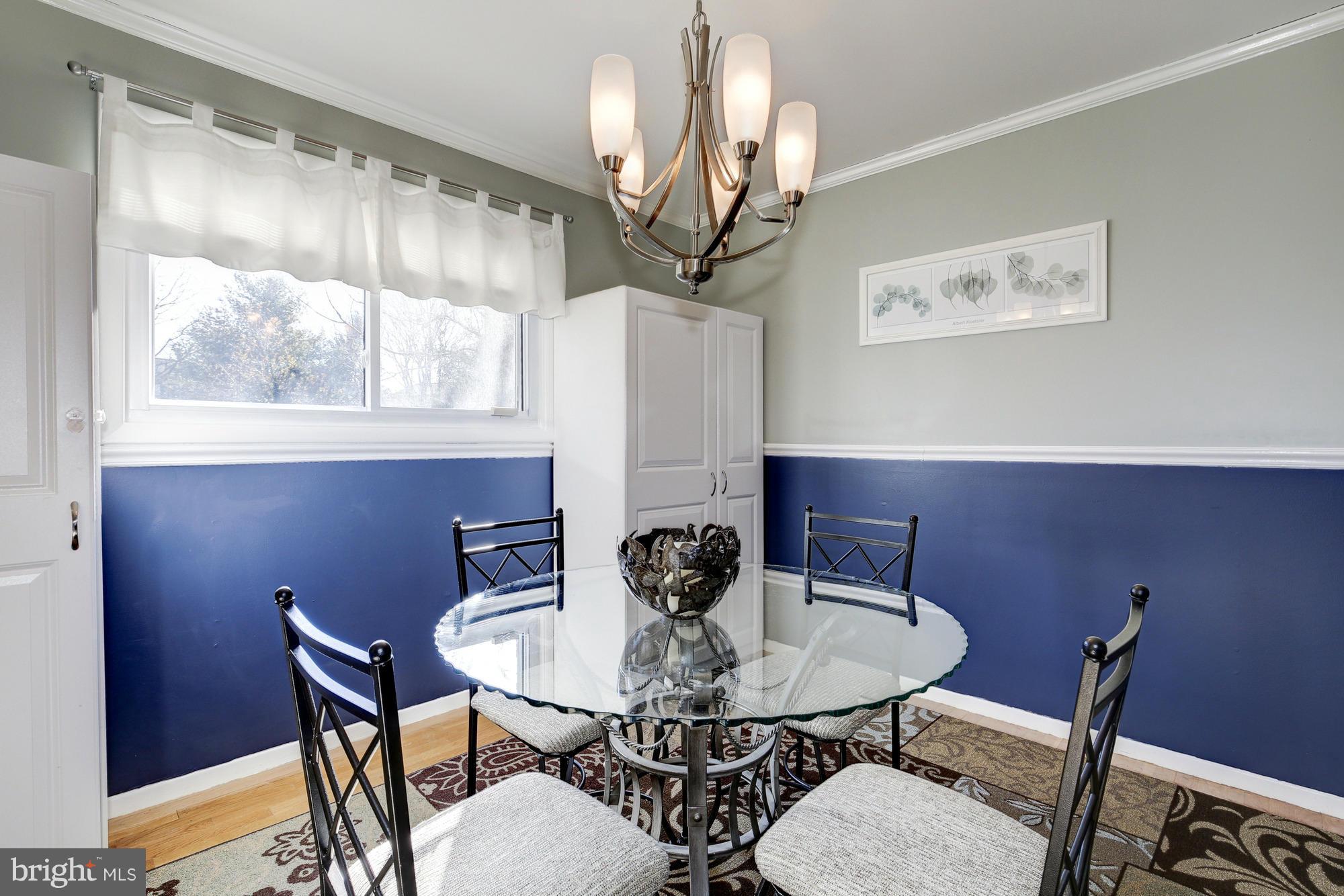 6505 Darwin Road Laurel, MD 20707 - Photo 5 of 30 a view of a dining room with furniture and wooden floor