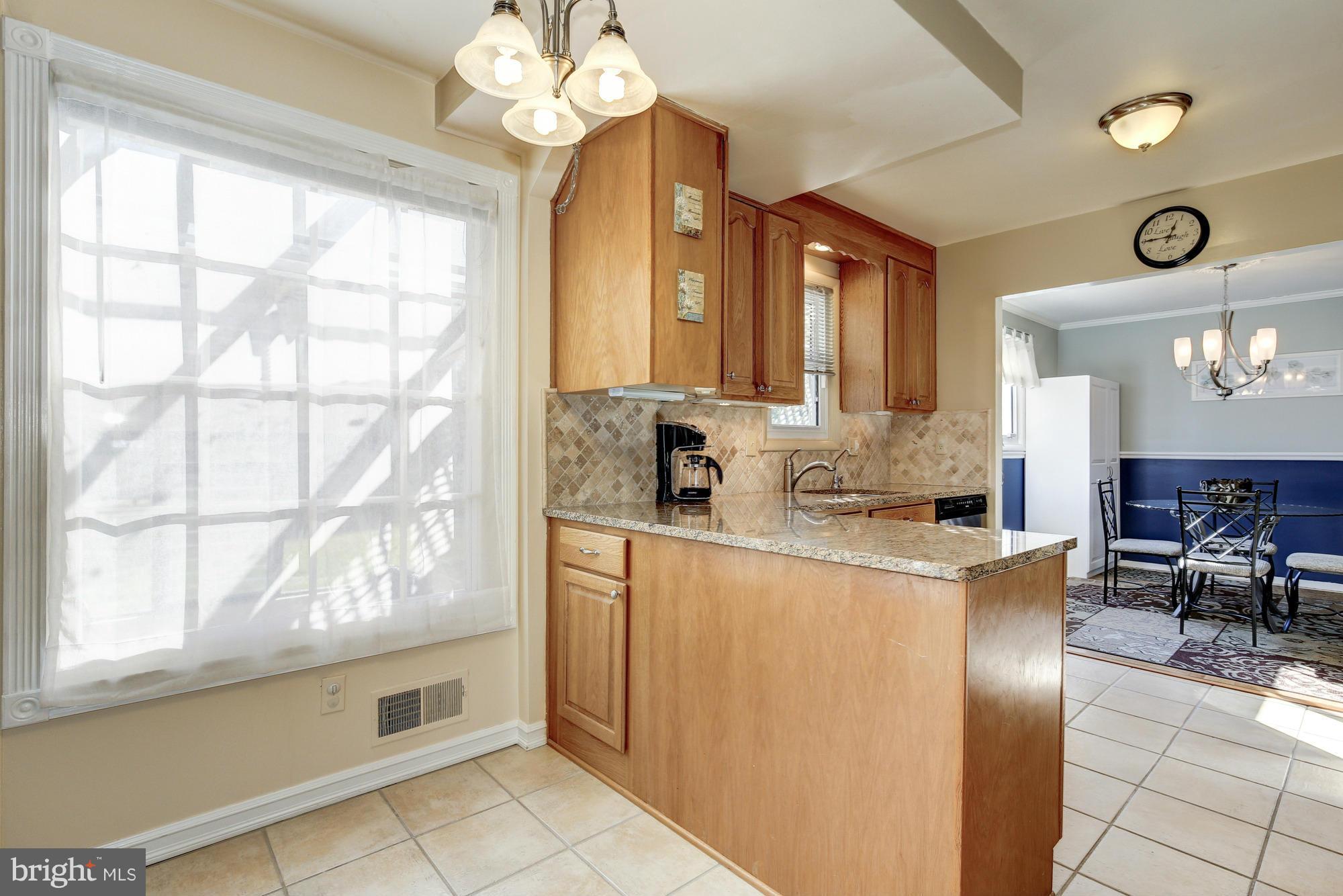 6505 Darwin Road Laurel, MD 20707 - Photo 10 of 30 a kitchen with stainless steel appliances granite countertop a stove a sink and a refrigerator