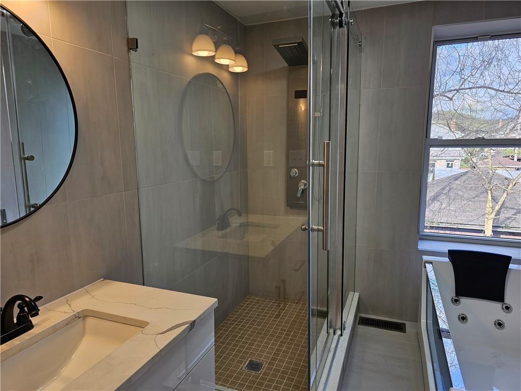 515 Connecticut Avenue Rochester, PA 15074 - Photo 12 of 20 a bathroom with a sink vanity and a mirror