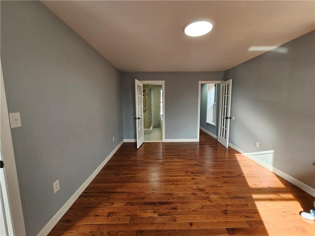 515 Connecticut Avenue Rochester, PA 15074 - Photo 18 of 20 a view of an empty room with window and wooden floor
