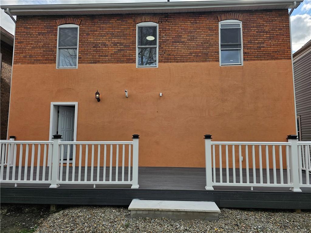 515 Connecticut Avenue Rochester, PA 15074 - Photo 4 of 20 a view of a brick house with a small yard
