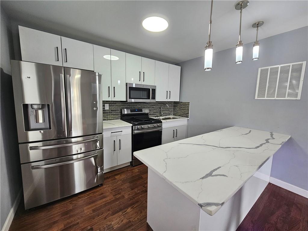 515 Connecticut Avenue Rochester, PA 15074 - Photo 5 of 20 a kitchen with stainless steel appliances a refrigerator sink and microwave