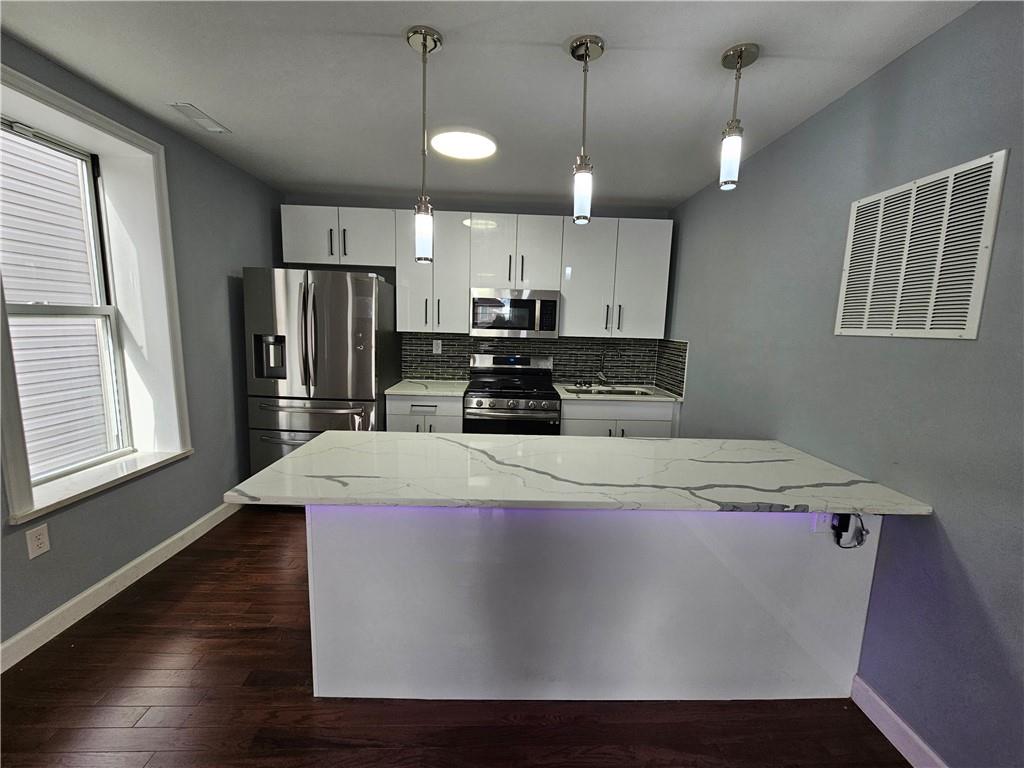515 Connecticut Avenue Rochester, PA 15074 - Photo 7 of 20 a large white kitchen with wooden floor