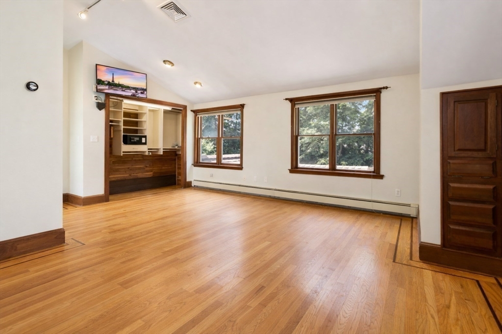 29 Boulevard Road Dedham, MA 02026 - Photo 19 of 34 an empty room with wooden floor and windows