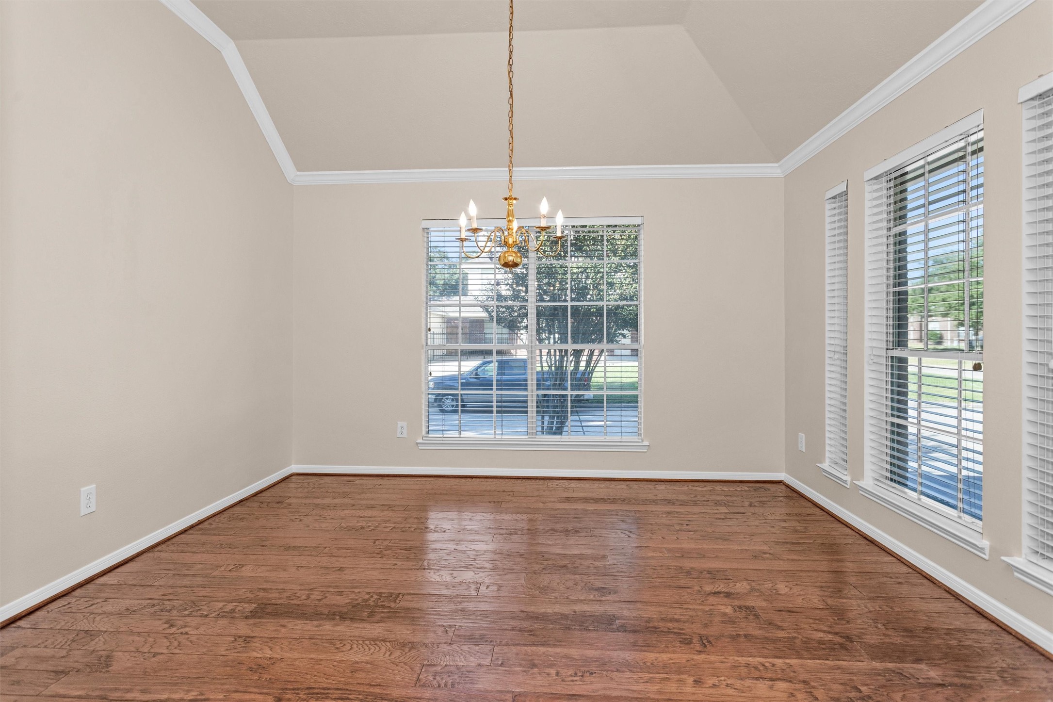 2615 Honeysuckle Walk Spring, TX 77388 - Photo 8 of 39 a view of an empty room with wooden floor and a window