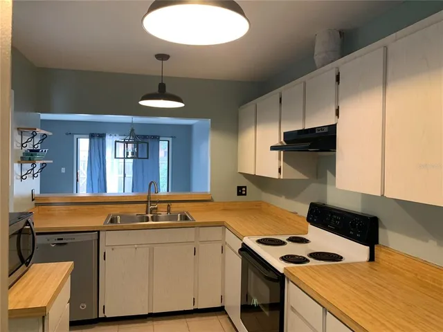 a kitchen with a sink cabinets and window