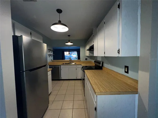 a kitchen with a refrigerator a sink and dishwasher