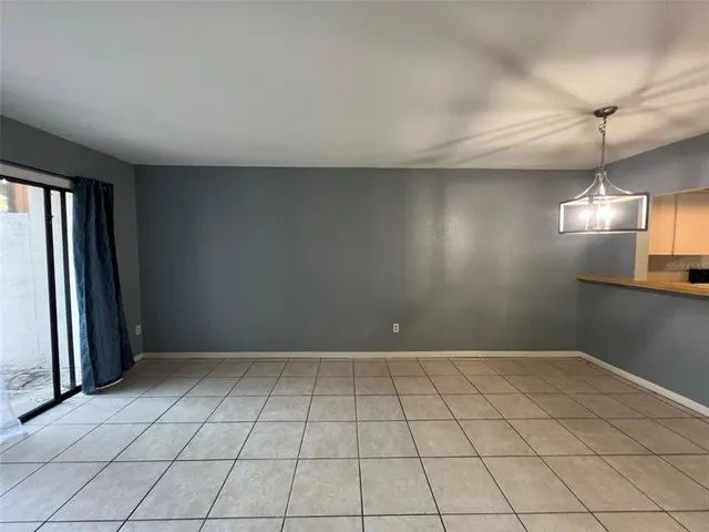 an empty room with staircase and mirror