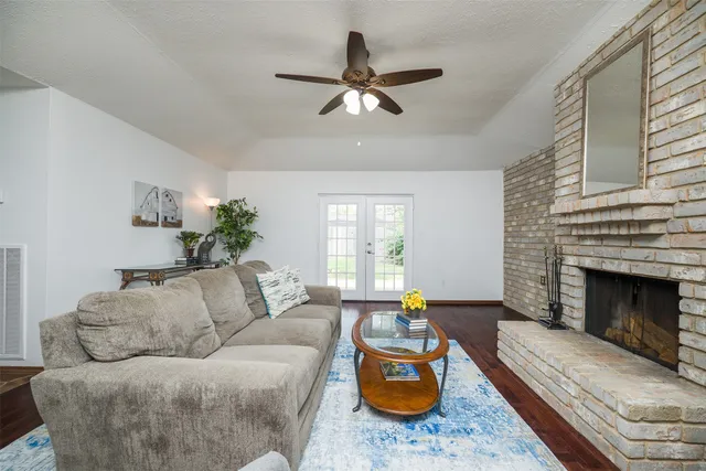 a living room with furniture fireplace and window