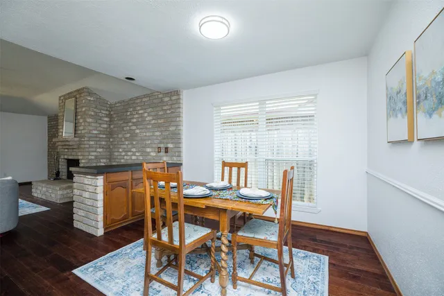 a dining room with furniture and wooden floor