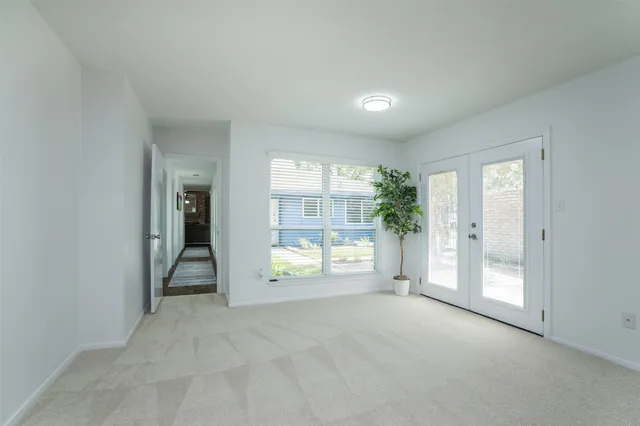 an empty room with windows and closet