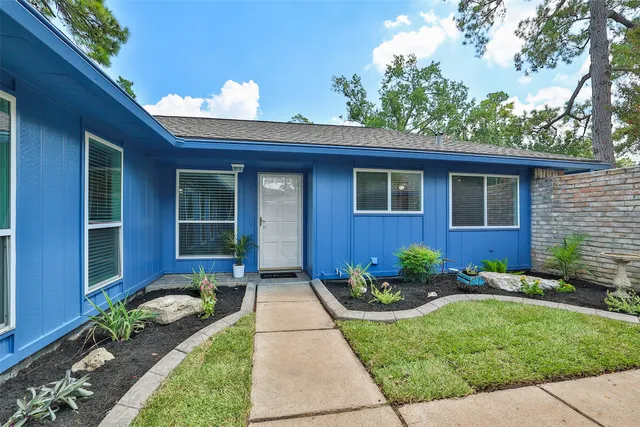 a front view of a house with garden