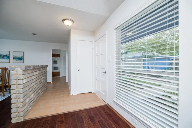 wooden floor in a room next to a window