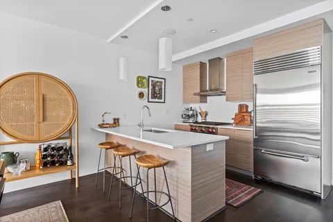 a kitchen with a sink a stove and cabinets