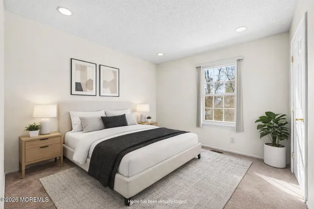 a bedroom with a bed and a potted plant