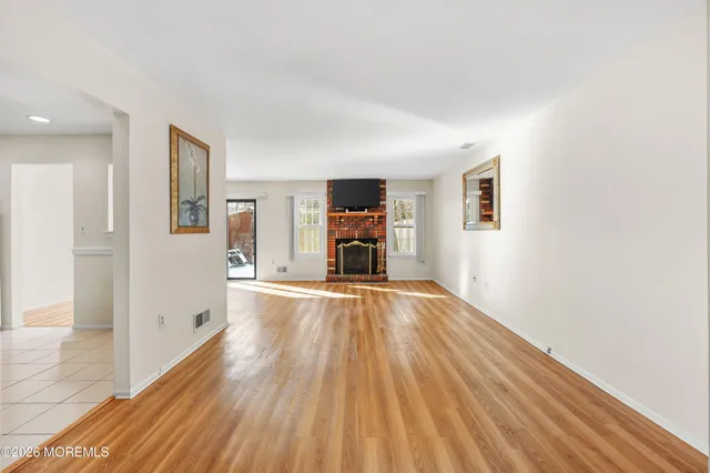 a view of a livingroom with wooden floor and furniture