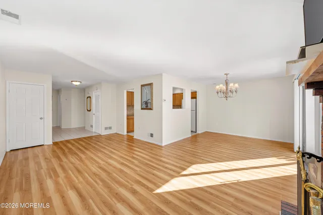 a bedroom with a large bed and a chandelier