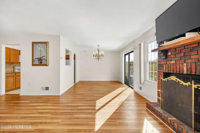a view of a bedroom with wooden floor