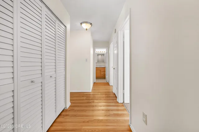 a view of a hallway with wooden floor