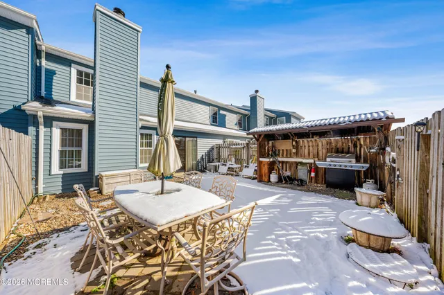 a view of a backyard with wooden fence