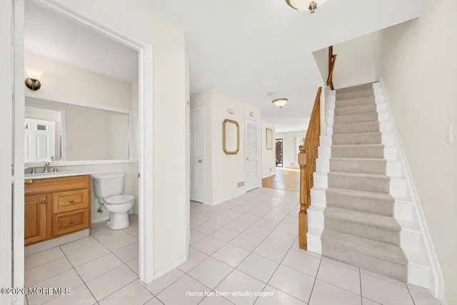 a bathroom with a sink a toilet and a mirror