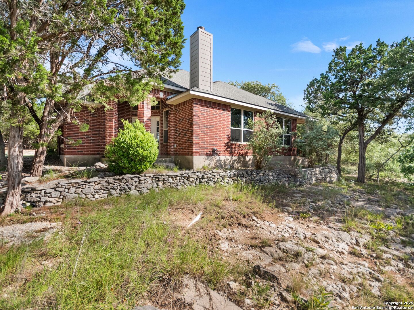 4366 Whartons Dock Road Bandera, TX 78003 - Photo 11 of 80 a front view of a house with garden