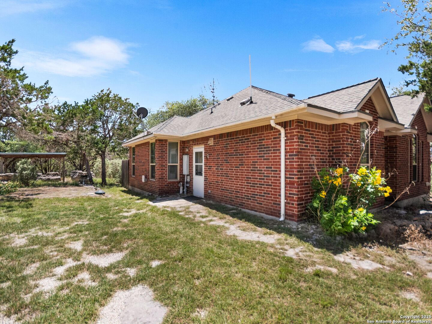 4366 Whartons Dock Road Bandera, TX 78003 - Photo 12 of 80 a front view of a house with a garden