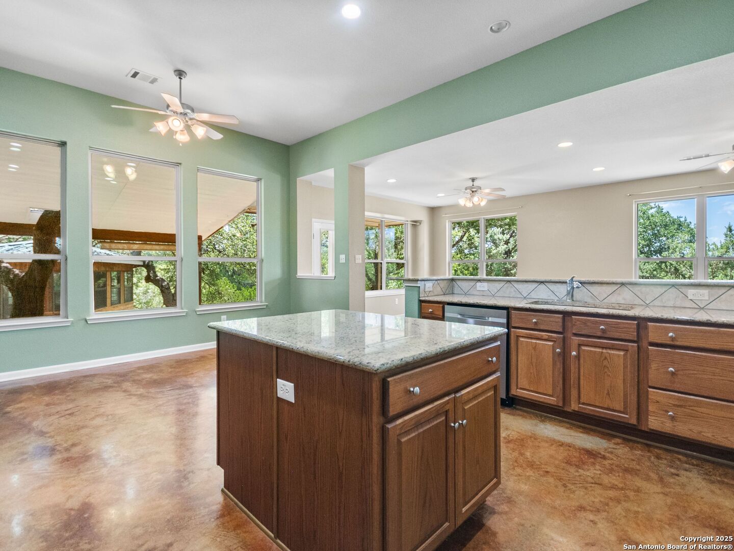 4366 Whartons Dock Road Bandera, TX 78003 - Photo 19 of 80 a kitchen with stainless steel appliances granite countertop a sink and a large window