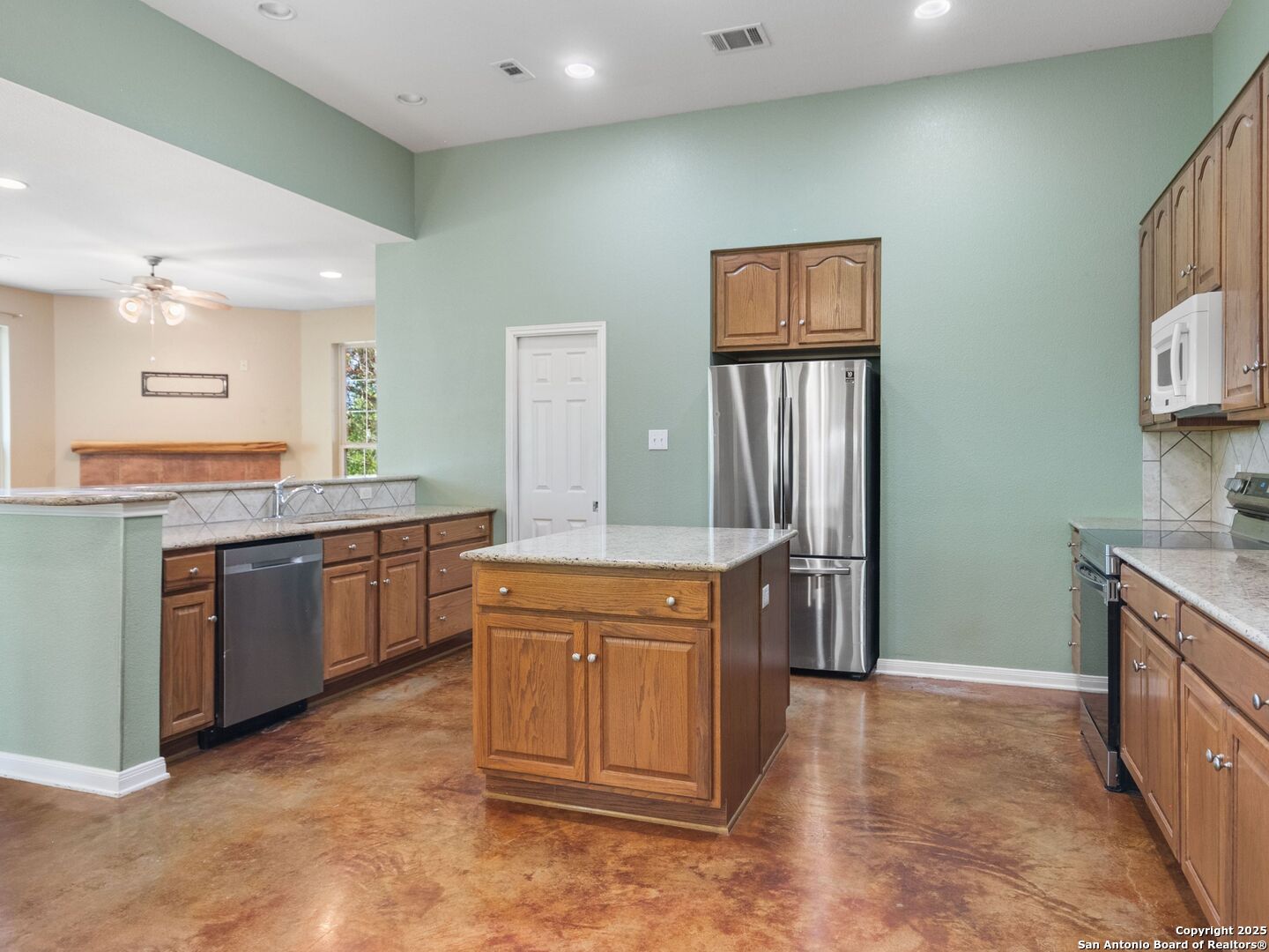 4366 Whartons Dock Road Bandera, TX 78003 - Photo 20 of 80 a kitchen with stainless steel appliances granite countertop a stove and a refrigerator