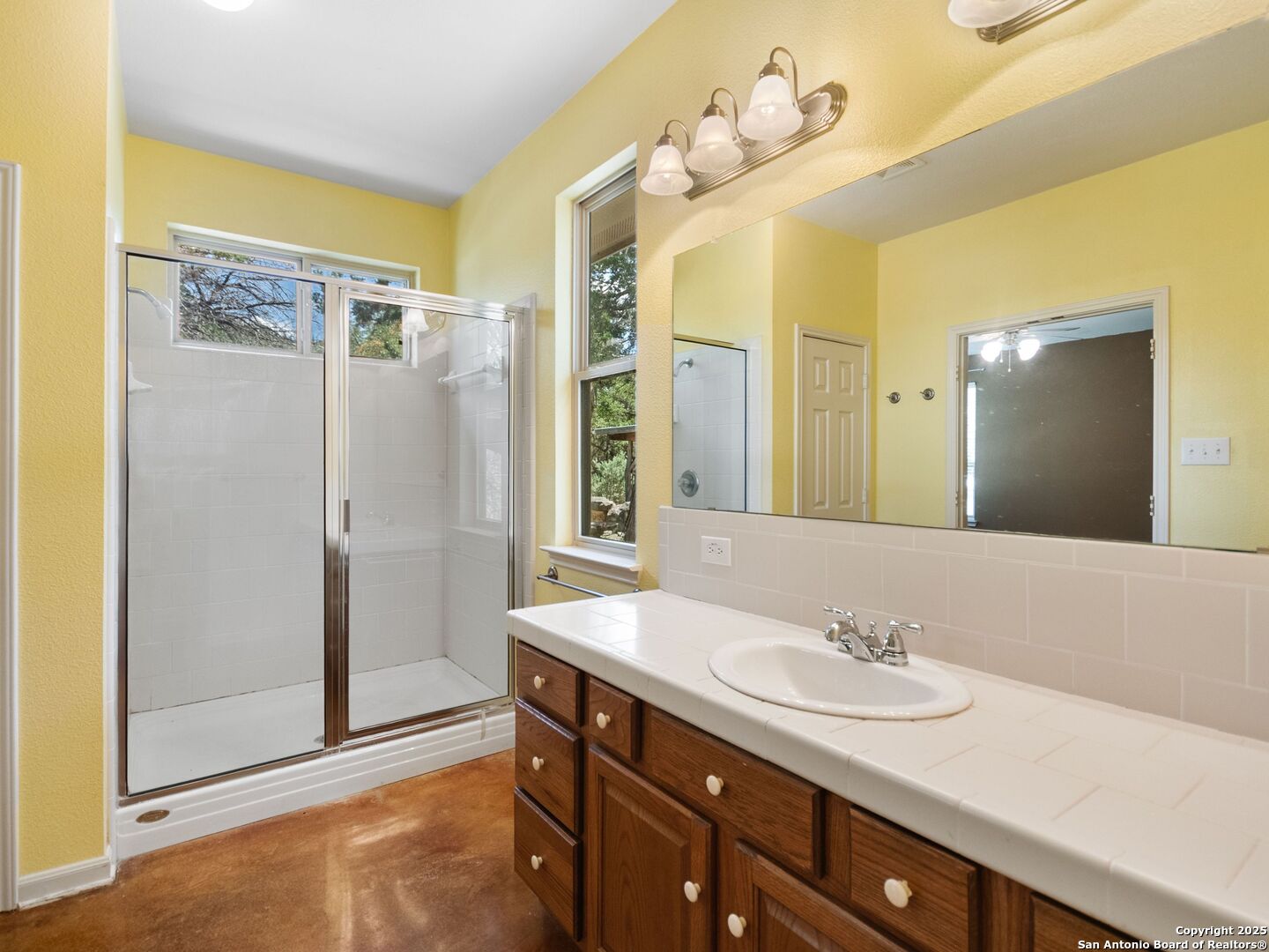 4366 Whartons Dock Road Bandera, TX 78003 - Photo 23 of 80 a bathroom with a sink and a mirror