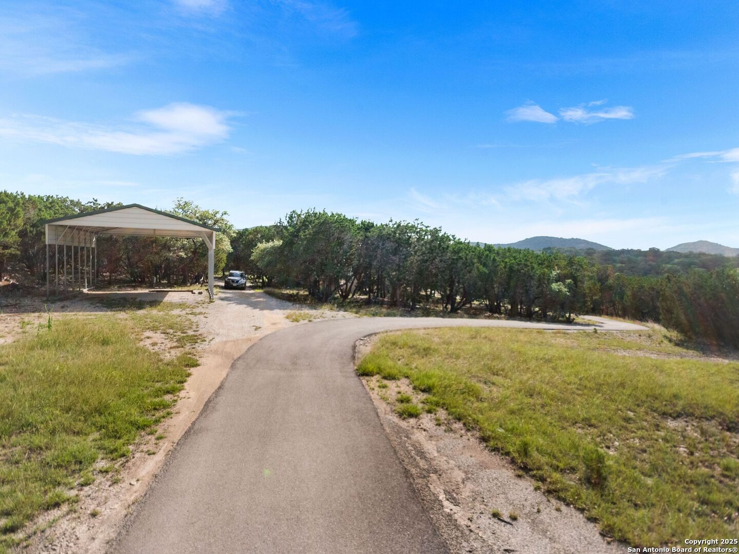 4366 Whartons Dock Road Bandera, TX 78003 - Photo 27 of 80 a view of swimming pool with a yard and large trees