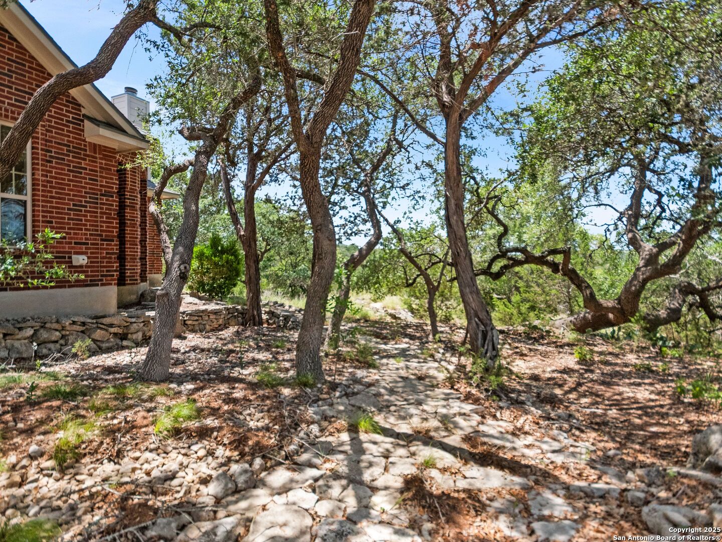 4366 Whartons Dock Road Bandera, TX 78003 - Photo 28 of 80 a backyard of a house with lots of green space