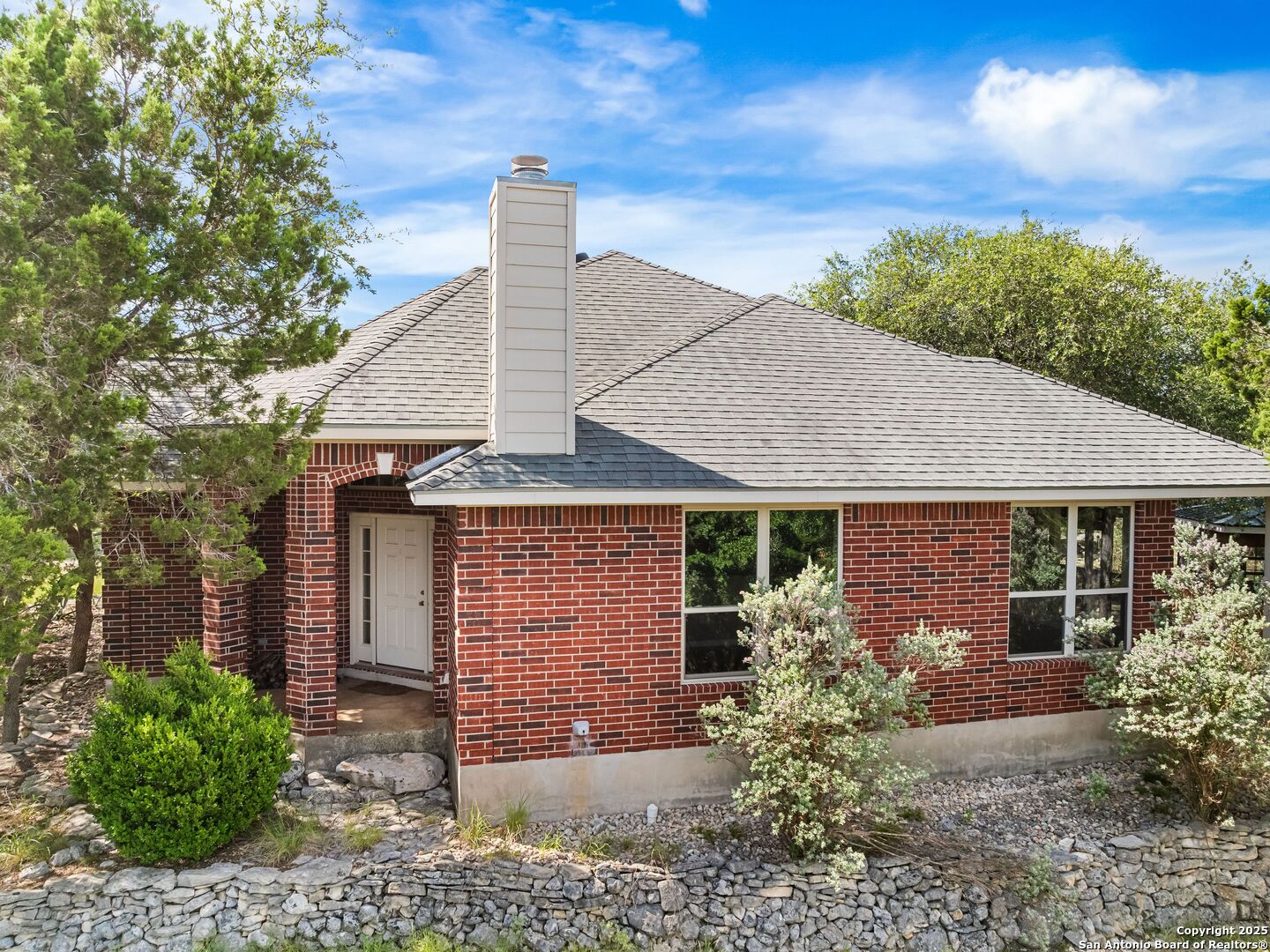4366 Whartons Dock Road Bandera, TX 78003 - Photo 29 of 80 a front view of a house with garden