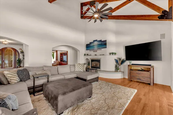 a spacious bedroom with a bed and a chandelier