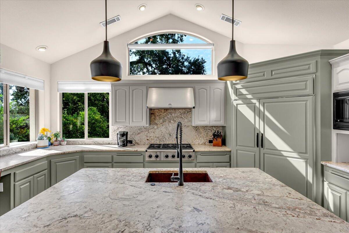 6681 Riverside Drive Redding, CA 96001 - Photo 30 of 124 a kitchen with stainless steel appliances granite countertop a sink and a stove
