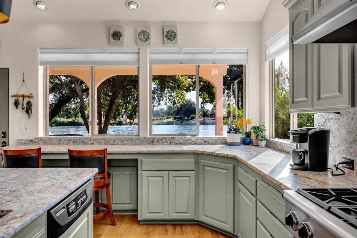 6681 Riverside Drive Redding, CA 96001 - Photo 34 of 124 a kitchen with stainless steel appliances granite countertop a stove and a sink