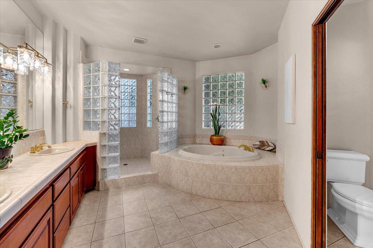 6681 Riverside Drive Redding, CA 96001 - Photo 49 of 124 a spacious bathroom with a tub sink and mirror