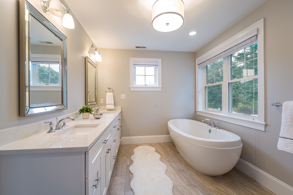 38 Westlake Road Natick, MA 01760 - Photo 23 of 36 a bathroom with a granite countertop sink and mirror bathtub