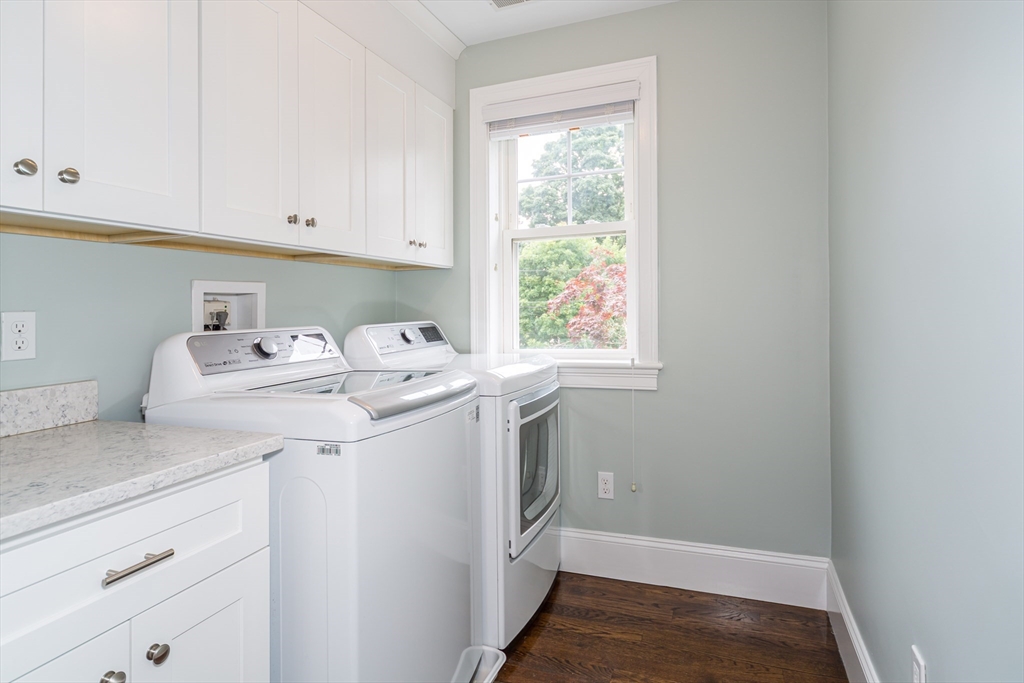 38 Westlake Road Natick, MA 01760 - Photo 26 of 36 a utility room with cabinets washer and dryer