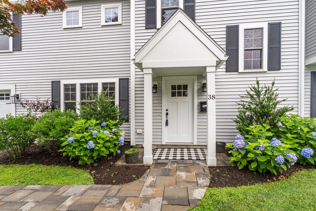 38 Westlake Road Natick, MA 01760 - Photo 3 of 36 a view of a brick house with a yard and plants
