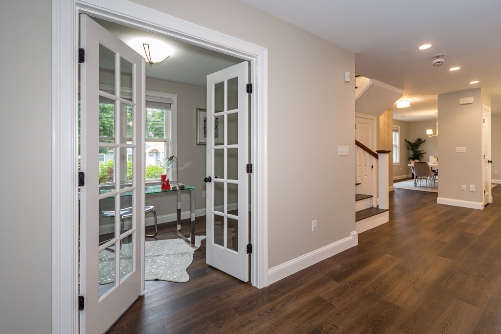 38 Westlake Road Natick, MA 01760 - Photo 8 of 36 a view of a hallway with wooden floor and a living room