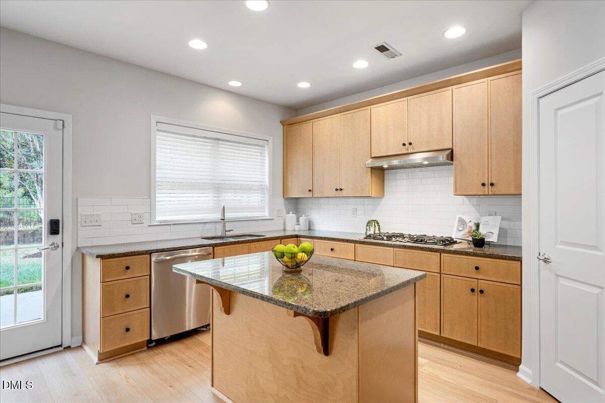 411 Amiable Loop Cary, NC 27519 - Photo 16 of 40 a kitchen that has a sink a stove counter space and cabinets
